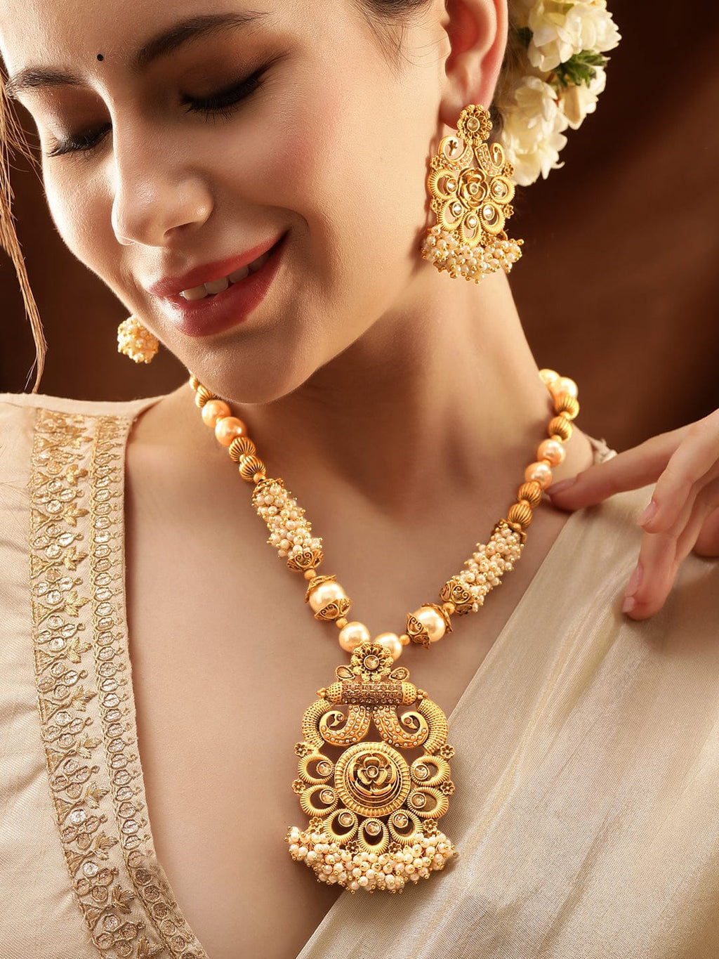 Gold-Toned Necklace Set with Radiant Charm exudes a captivating allure