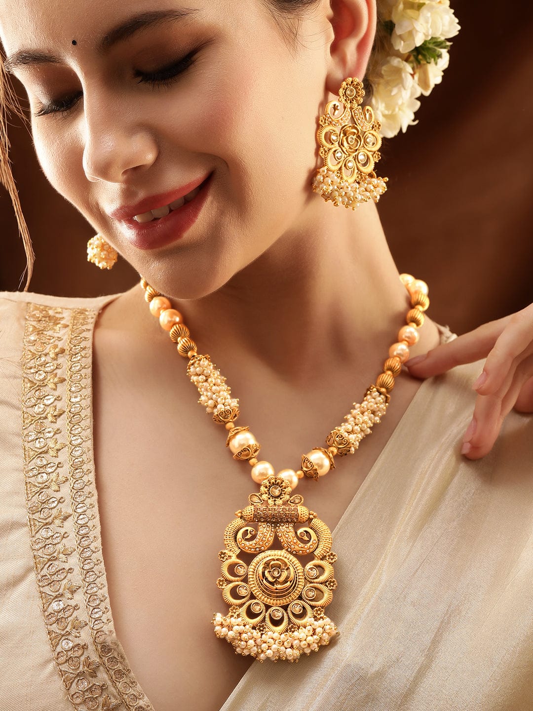 Gold-Toned Necklace Set with Radiant Charm exudes a captivating allure