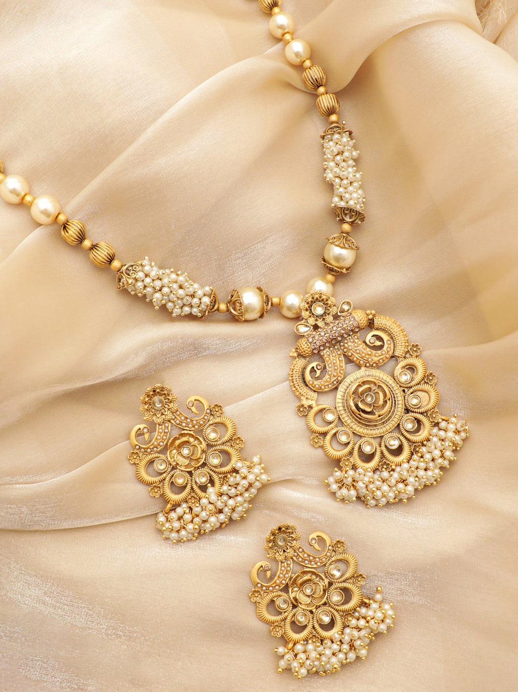 Gold-Toned Necklace Set with Radiant Charm exudes a captivating allure